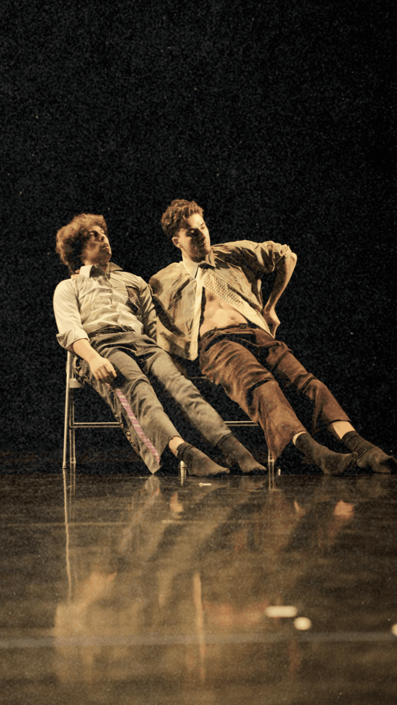 Performers seated on stage